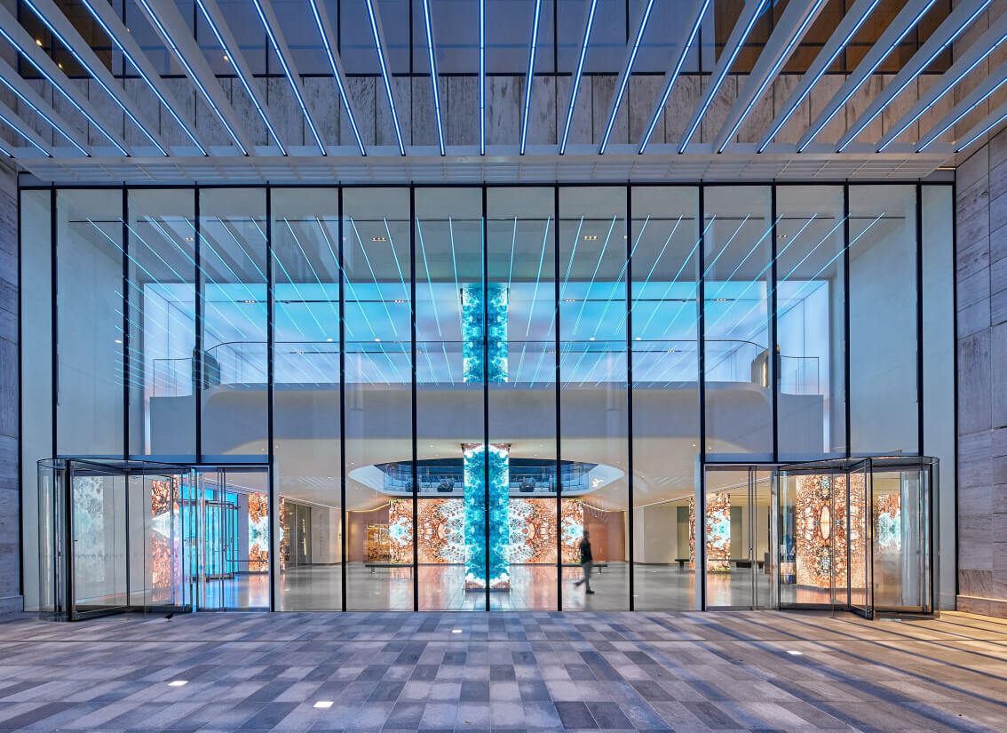 Front lobby of glass building featuring visual elements produced by Electrosonic