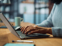 Professional typing on a laptop in an office