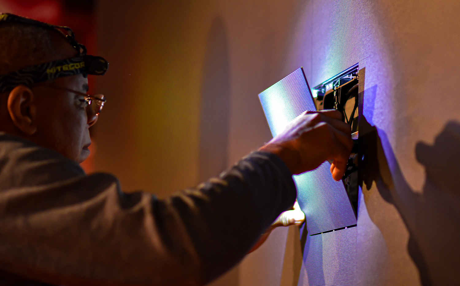 An Electrosonic support technician replacing an LED panel.