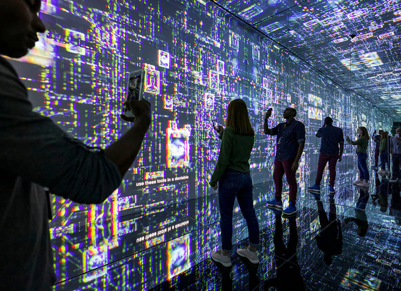 Guests to the International Spy Museum enjoying the infinity room which combines mirrors, projectors and XR technology to create a unique immersive experience.