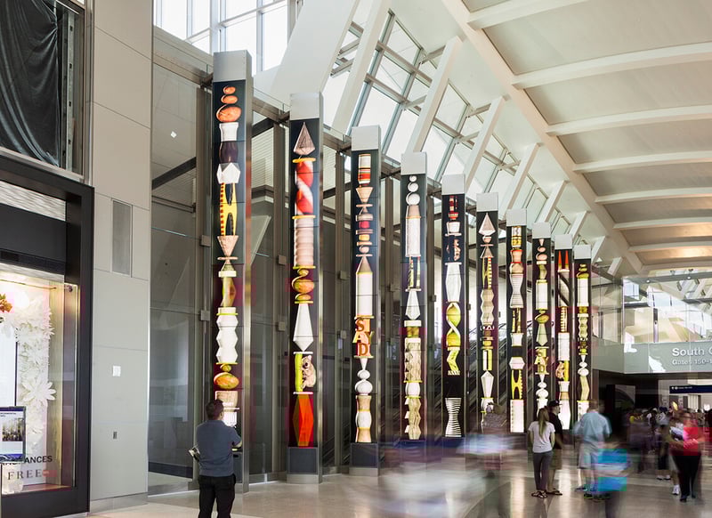 Visitors walking past several LED totems at a retail environment.