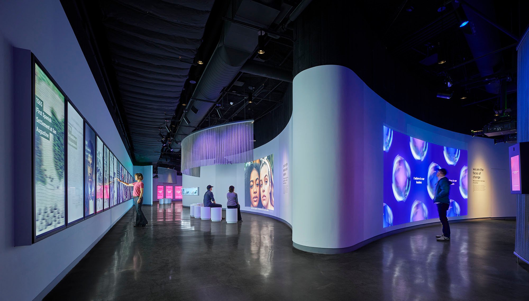 Guests interacting with various digital exhibits at the Museum of Tolerance. 