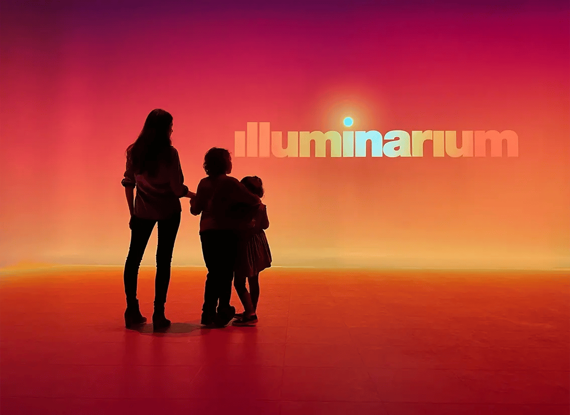Three guests viewing the projection experience at Illuminarium, Atlanta.