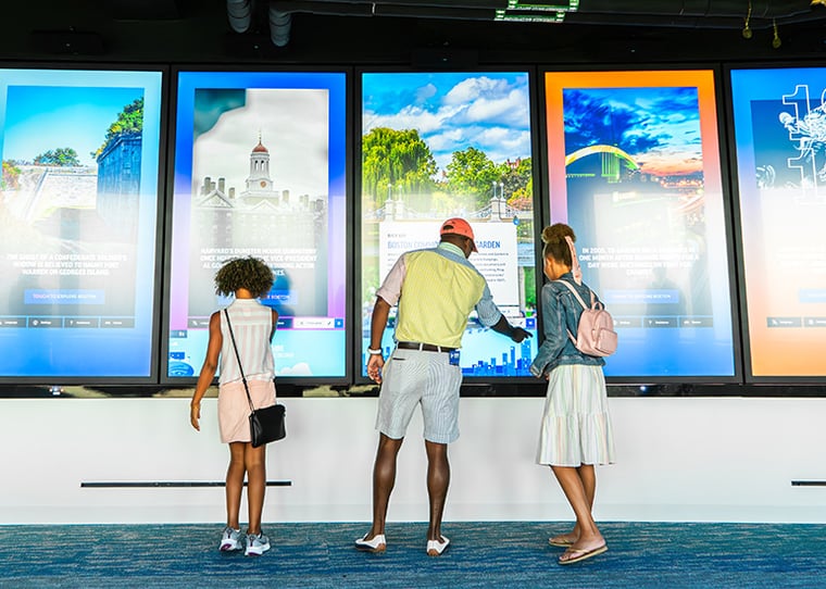 Guests interacting with touchscreens at View Boston.