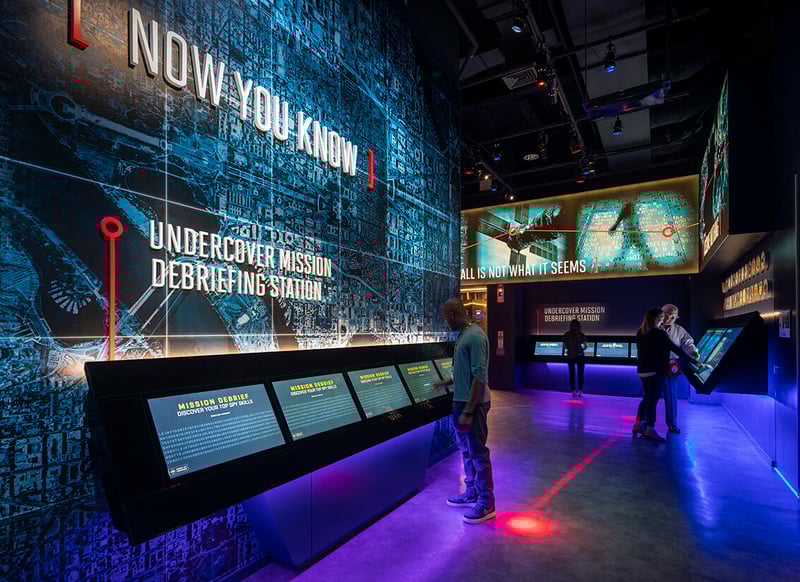 Visitor to the International Spy Museum interacting with one of a series of touchscreens at the Museums entrance.